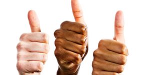 ouce_reconnaisance Three hands of different ethnicities, two male and one female, join in giving a hearty thumbs up of approval, isolated against white.